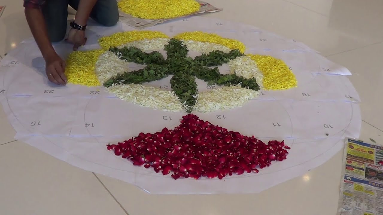 big onam flower rangoli design with fragrant flowers