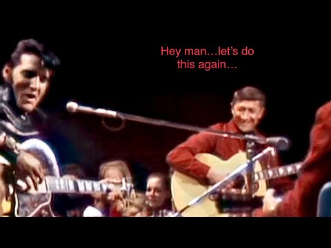Scotty Moore smiles at Elvis while playing “Tiger Man”