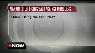 Man on toilet fights back against intruders