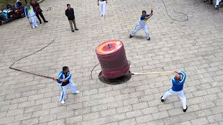 Strange Technique to Spin Gigantic Top in Middle of Street