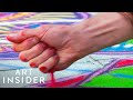 How This Artist Turned Traditional Sand Painting Into Street Art