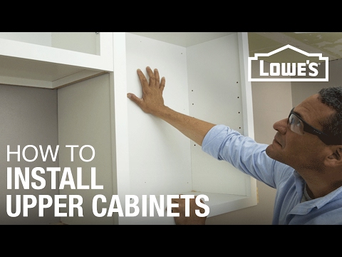 Part of a video titled How to Hang Cabinets - YouTube