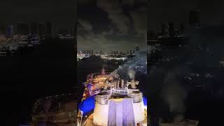 Back Poolside of Royal Caribbean Freedom of the Seas epic drone night lights with Miami City Skyline