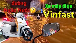 Vinfast Klara S2 electric motorbike wades through flood water. It's best to take a day off from w...