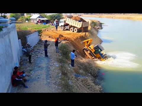 Relentless Road Reinforcement: D60P Dozer Fights Solid Rock with Nonstop Truck Loads