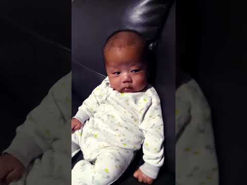 baby Joshua sitting on the couch