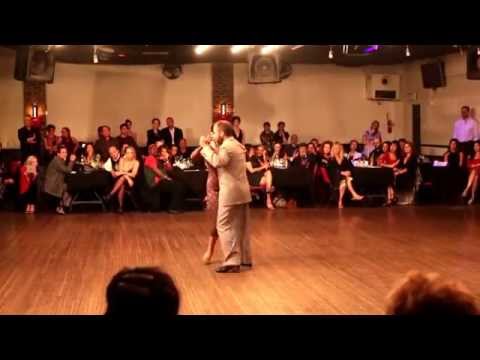  Oliver Kolker  and  Yuliana Basmajyan  are  dancing  to  the  milonga  "  Flor de Monserat  "  by  Rodolfo Biagi