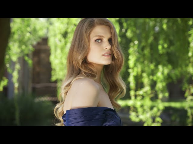 ‏ Off-shoulder gown with ruffle skirt