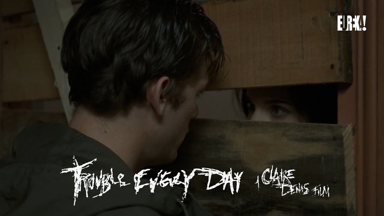 Coré encounters a man in a drab apartment