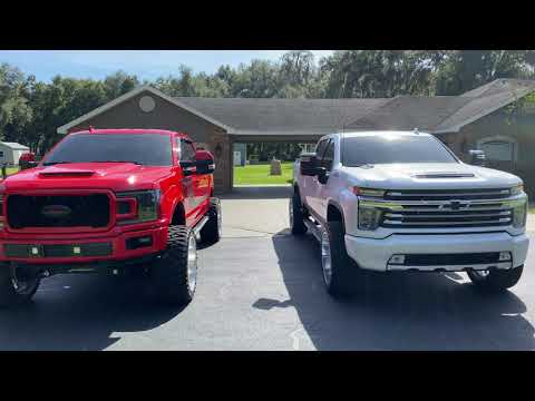 2020 Chevy High Country 2500hd on 24x12 wheels and 325/45/24 tires raised front and trimmed