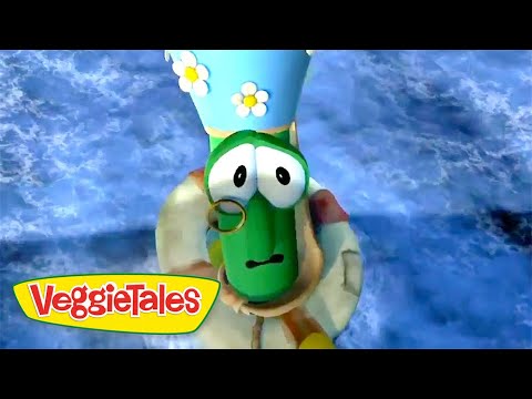 Green cucumber character from VeggieTales wearing a blue hat with daisies and a monocle against a blue background.