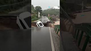 Bridge collapse in China sends car into swollen river during severe flooding