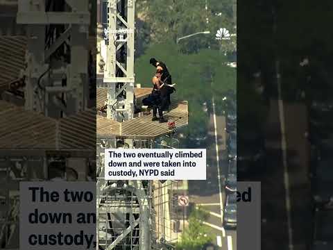 Trespassers appear to get engaged on top of the Empire State Building