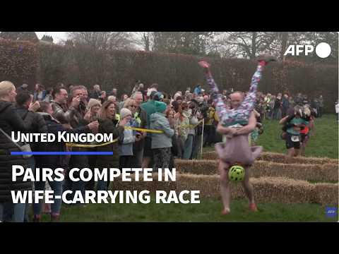 Video Thumbnail: Pairs compete in quirky UK Wife Carrying Race | AFP