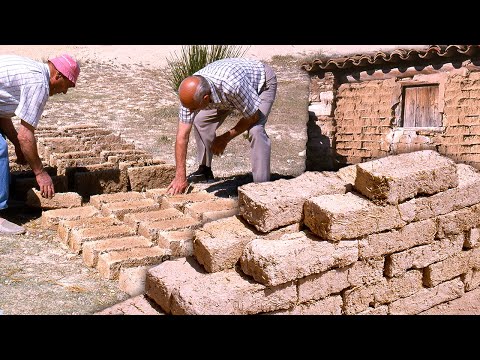 Walls of earth, water, and straw by hand to build a village house using ancient techniques