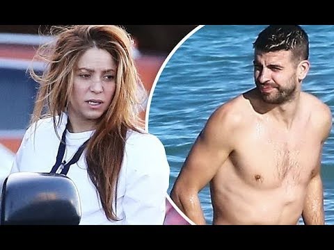 Shakira bundles up while hunky footballer beau Gerard Pique strips down for a Christmas Eve swim in
