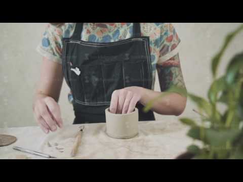 Woman making pottery by hand. Stylish tableware