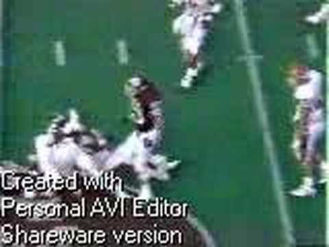 Aaron Wallace holds up Andre Ware's helmet