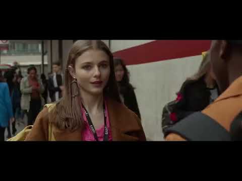 Last Night in Soho official trailer frame: Eloise bathed in neon walking through Soho at night