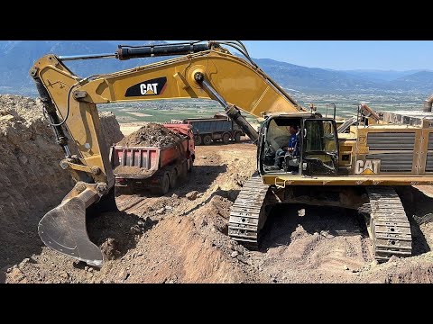 Caterpillar 390D Excavator Loading Caterpillar 775E Dumper And Trucks
