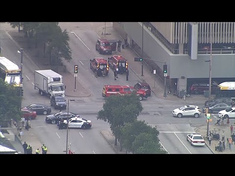 A masked gunman opened fire Monday on a federal courthouse in downtown Dallas before being fatally shot in an exchange of gunfire with federal officers, witnesses and authorities said. (June 17)