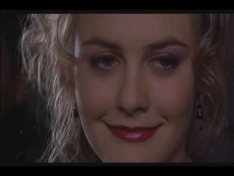 Alternate trailer still of Alicia Silverstone with city lights behind her in Blast from the Past