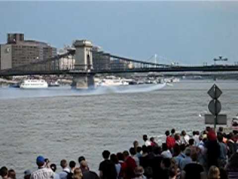 airplane flying under the famous  Danube's "chain bridge" in Budapest