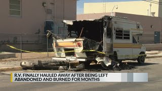 Burned R.V. finally hauled away after being left abandoned