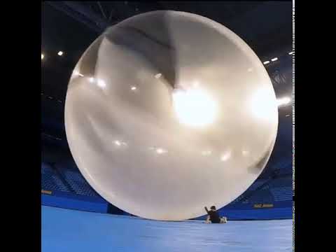 Giant weather balloon bursting in slow motion