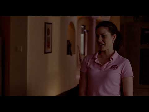 Trailer still of Rose and Norah in protective suits sharing a laugh after a job