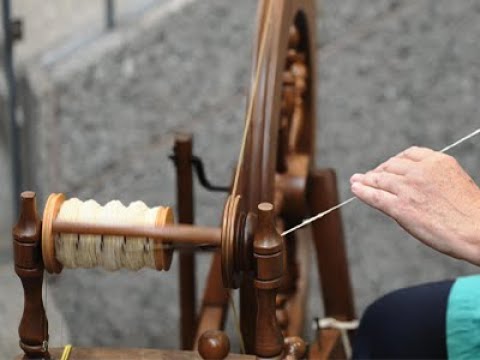Part of a video titled What is a spinning wheel and how does it work? - YouTube