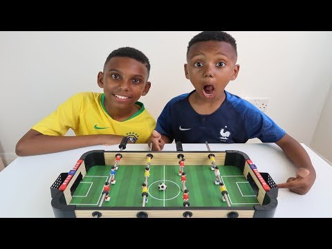KID PLAYS TABLE TOP FOOTBALL VERSE BIG BRO - YouTube