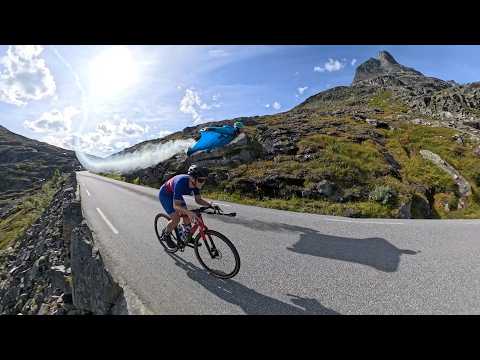 Wingsuit Pilot Races Past a Bus and Cyclist