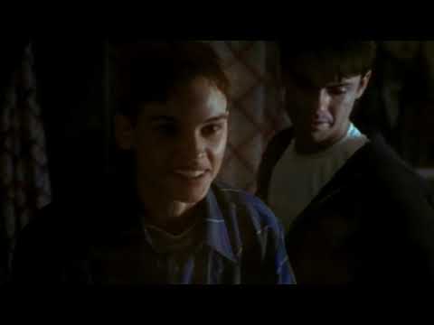 Boys Don’t Cry trailer frame—Lana and Brandon in a dim karaoke bar with neon reflections
