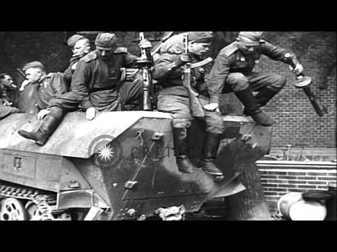Russian troops riding on captured German half-track in a German town, at end of W...HD Stock Footage