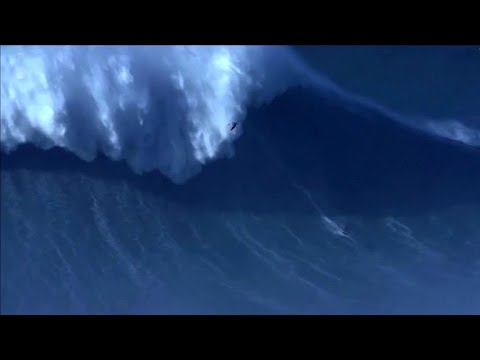 Surfer breaks world record by riding 80-foot wave