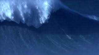 Surfer breaks world record by riding 80-foot wave