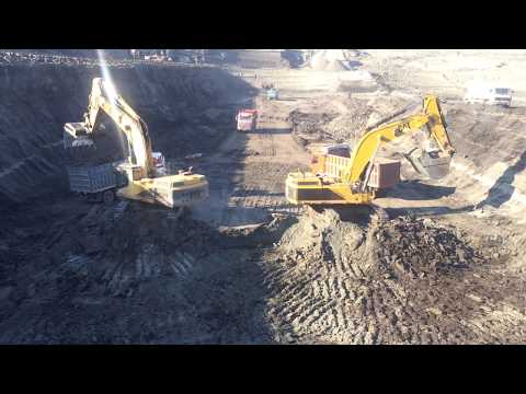 Two Caterpillar 375 Excavators Loading By Side
