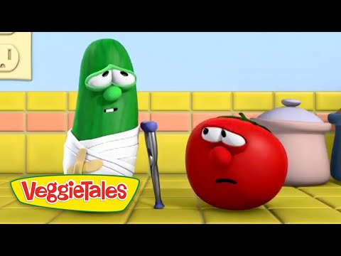Green cucumber with a white bandage and crutch speaks to a worried red tomato in a bright yellow kitchen, VeggieTales scene.