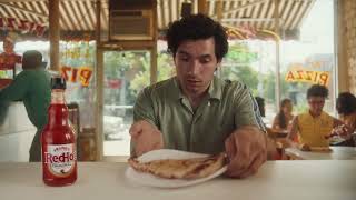 Frank's RedHot Man leaves pizzeria with a slice of pizza