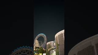 観覧車の上空を通過していく国際宇宙ステーション