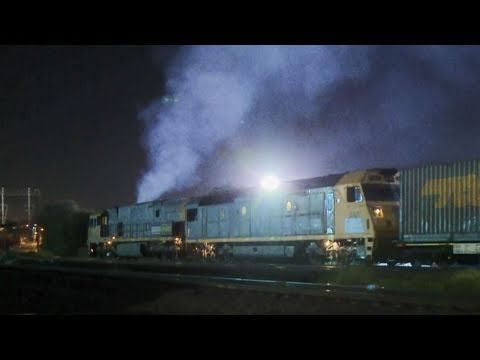 Smokey Pacific National Locomotives with a long freight train in Melbourne.