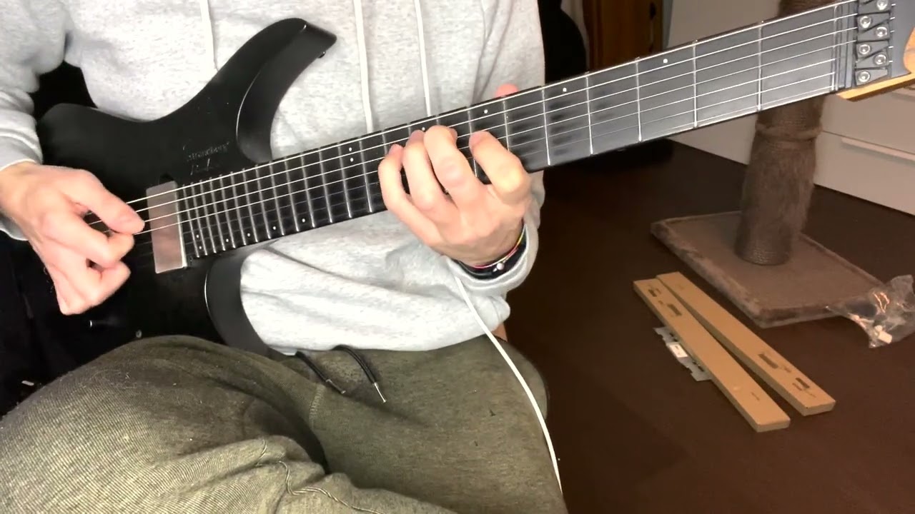 Guitarist playing the Paint It Black riff on a single guitar