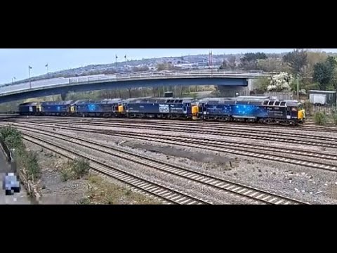 Class 57 hauling 4 class 47s passes Derby