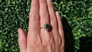 A pear shaped Emerald and Diamond cluster ring