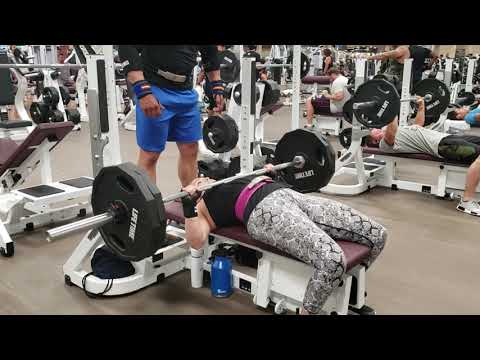 Female bench presses 225lbs for reps