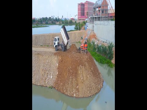 Relentless Road Reinforcement: D20P Dozer Fights Solid Rock with Nonstop Truck Loads