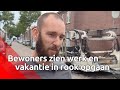 Bewoners bekijken de schade na zes branden in Tilburg