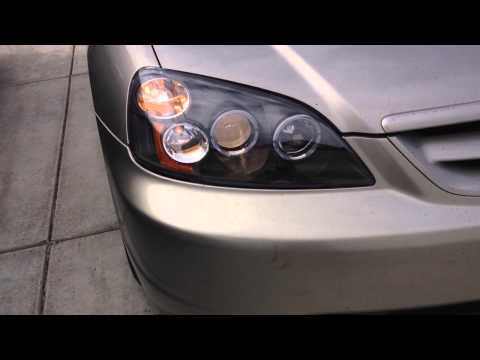 Aftermarket halo projector headlights installed on honda civic 2002