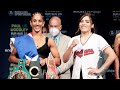 AMANDA SERRANO FLEXES HER CHAMPIONSHIP HARDWARE IN FRONT OF YAMILETH MERCADO AT FINAL WEIGH IN